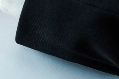 Person in suit sealing a document with a wax stamp on a wooden desk.