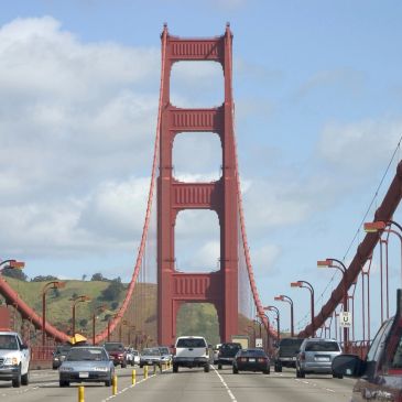 The Golden Gate Bridge with cars on a sunny day.