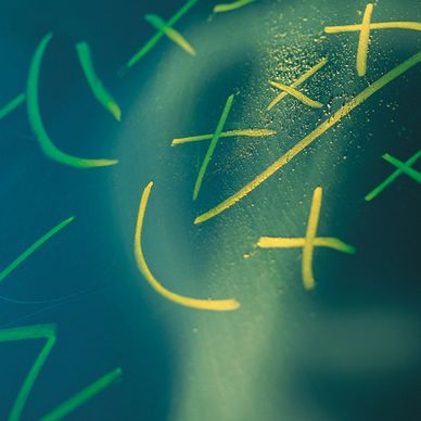 Close-up of game strategy drawn with yellow and green markers on glass.