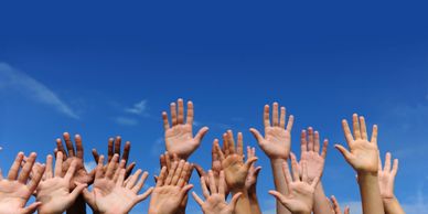hands reaching to address social and racial disparities