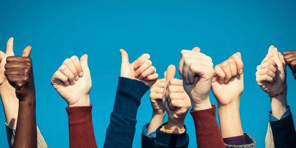 Group of people giving thumbs up