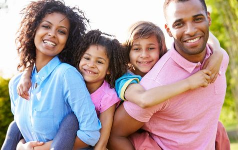 family photo of a woman, two kids, and a man