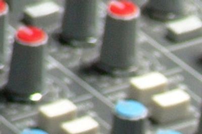 Close-up of audio mixer knobs and controls.