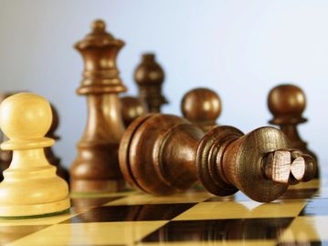 Chess pieces on a board after checkmate.