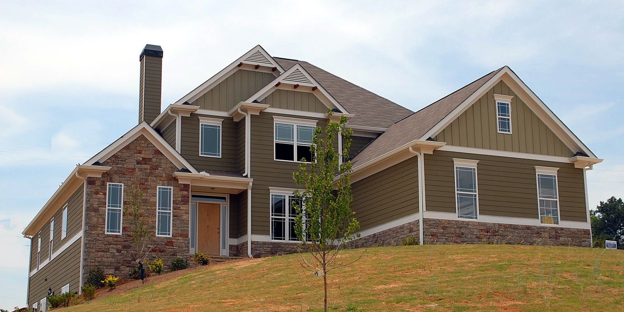 A beautiful rental home on a hill with green grass representing Greenville property management.