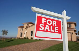 For sale sign in front of a home.