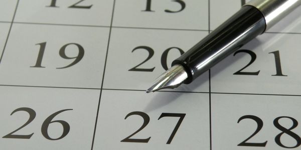 calendar with a pen laying on it