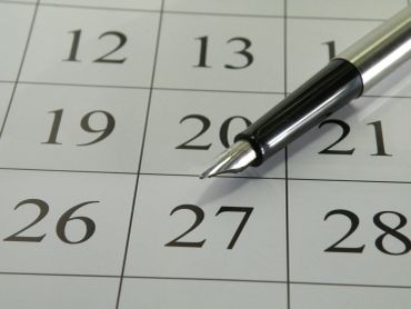 Close-up of a pen on a calendar date 27.