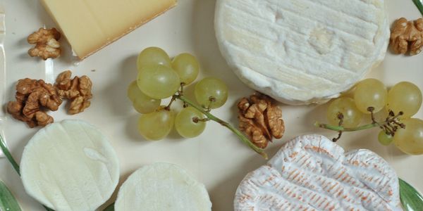 Plate of cheese, grapes, and walnuts.