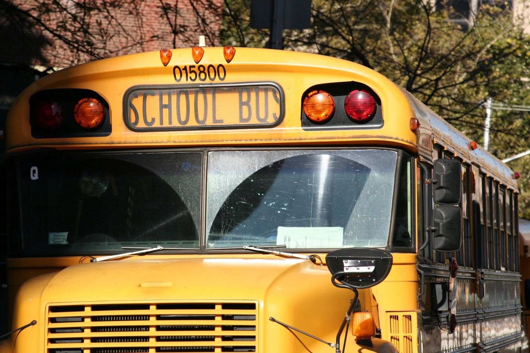 Front view of a yellow school bus with its sign visible.