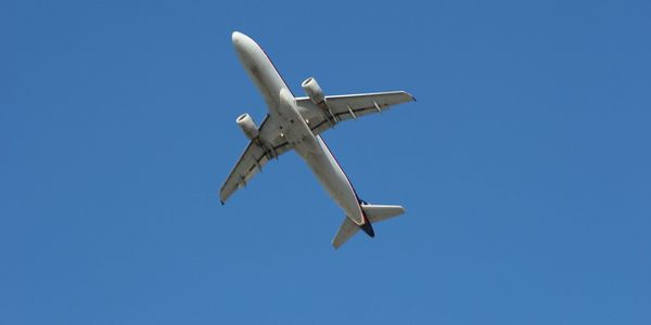 Plane flying in clear blue skies.