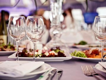 Elegant table setting with wine glasses and plated dishes for a formal meal.