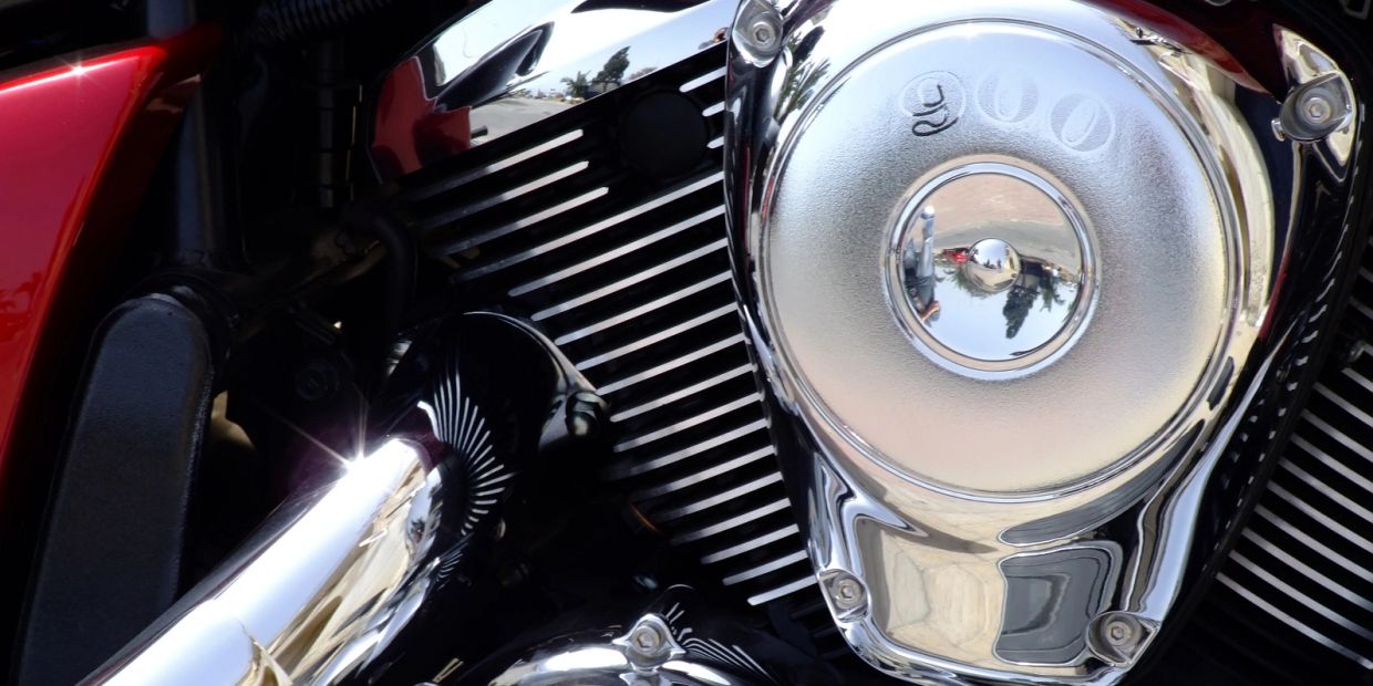 Close-up of a shiny motorcycle engine with '900' engraved.