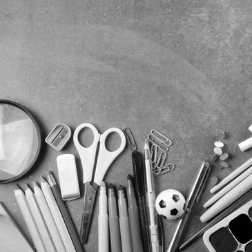 Various stationery items arranged neatly on a textured surface.