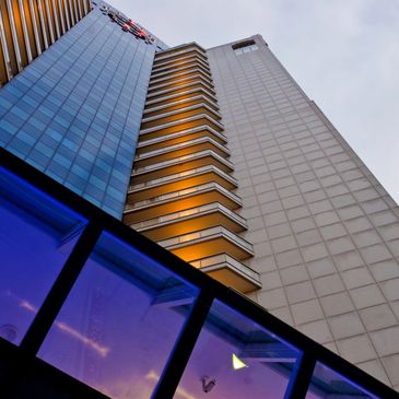 Outside of large hotel building at sunset.