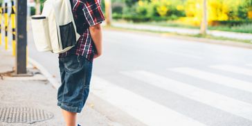 Child waiting to safely cross the street