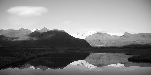 A lake with a mountain range in the horizon