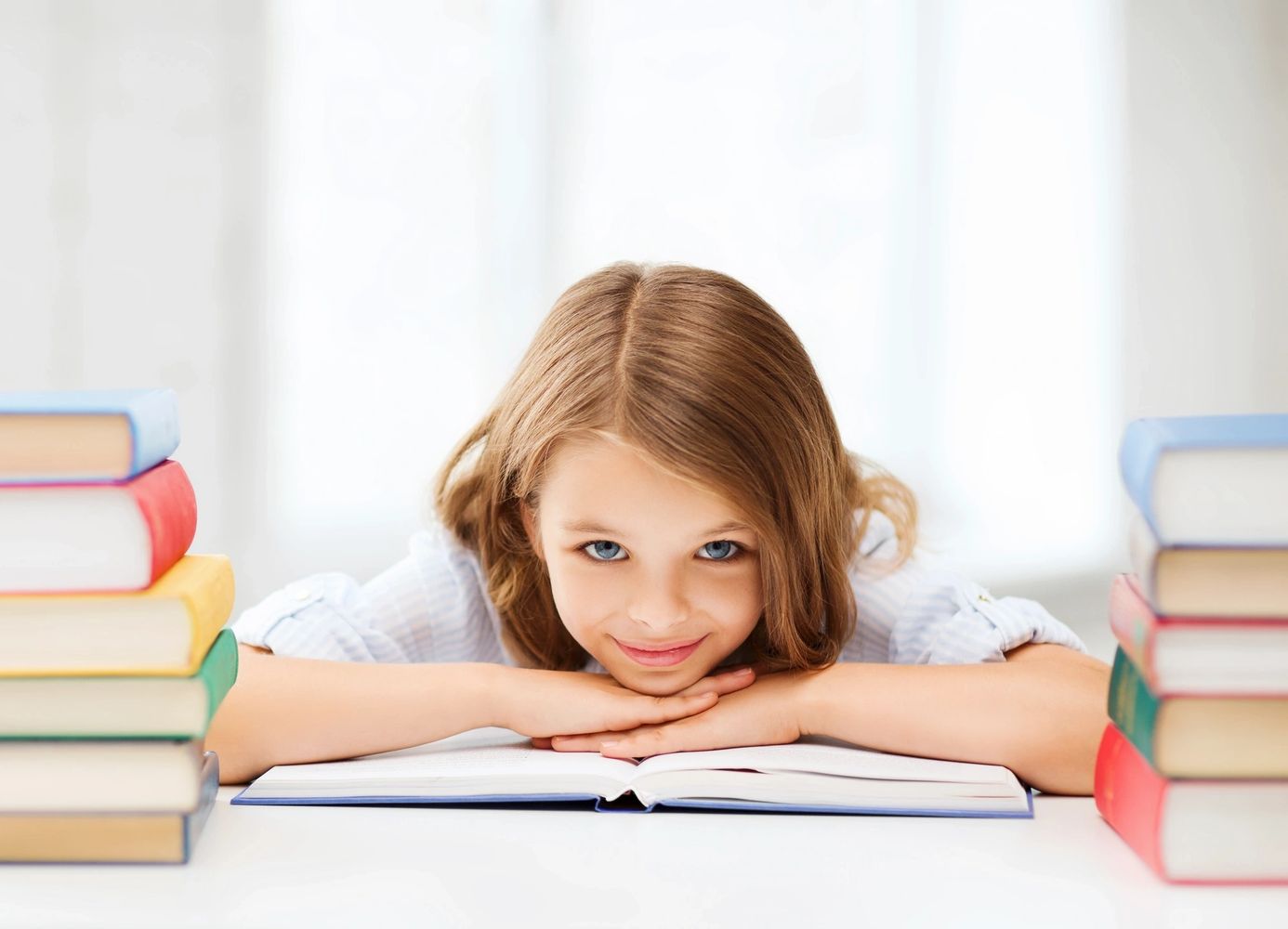 Girl smiling between her books