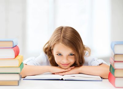 A girl surrounded by books