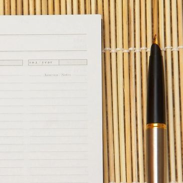 Edge of a calendar or planner with a fountain pen.