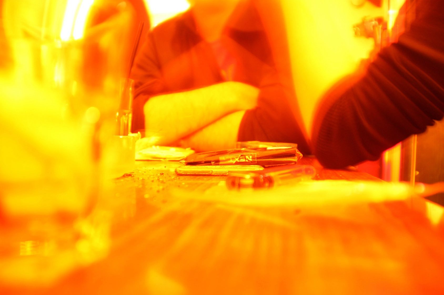 A blurry picture of a person sitting at a table.