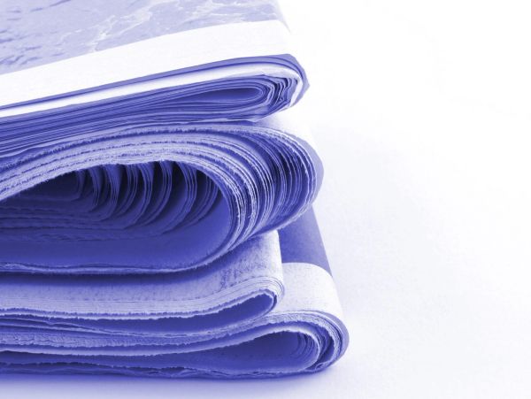 Stack of folded newspapers.