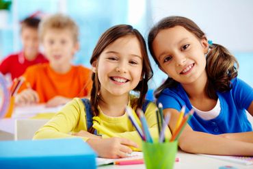 2 children smiling and drawing