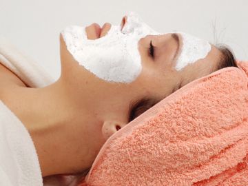 woman with facial mask relaxing