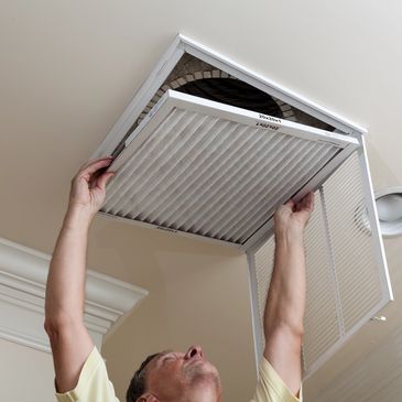 Handyman changing AC Filter