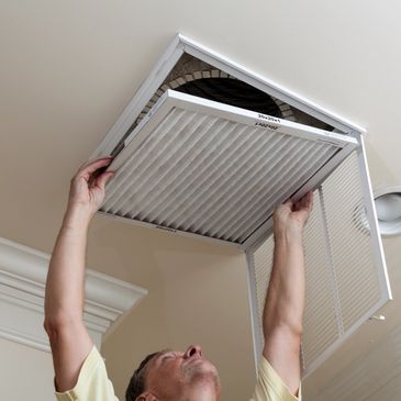 HVAC technician replacing AC Filters