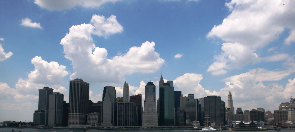 City skyline under a partly cloudy sky.