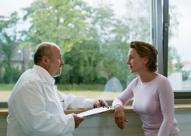 A woman consulting a male therapist