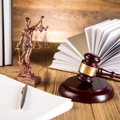 Estate planning documents set out on a desk with other decor.