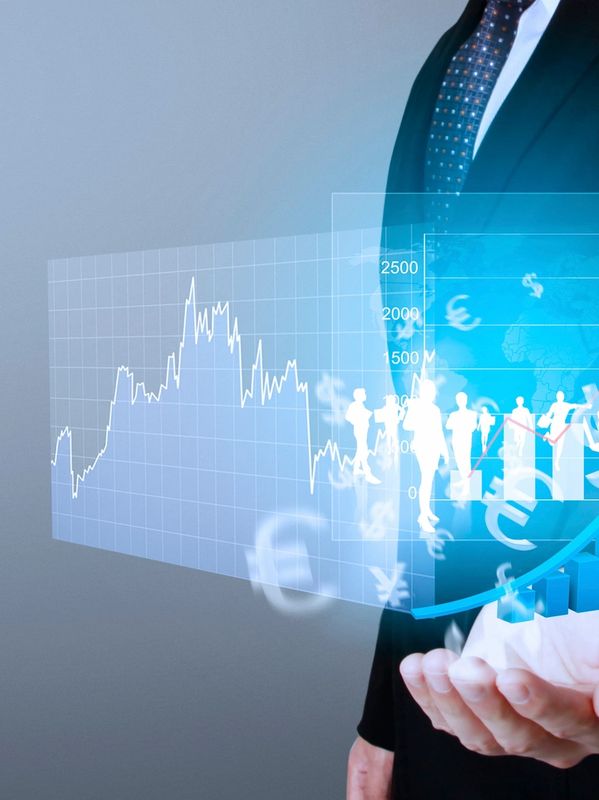 Businessman presenting futuristic financial and economic data visuals.