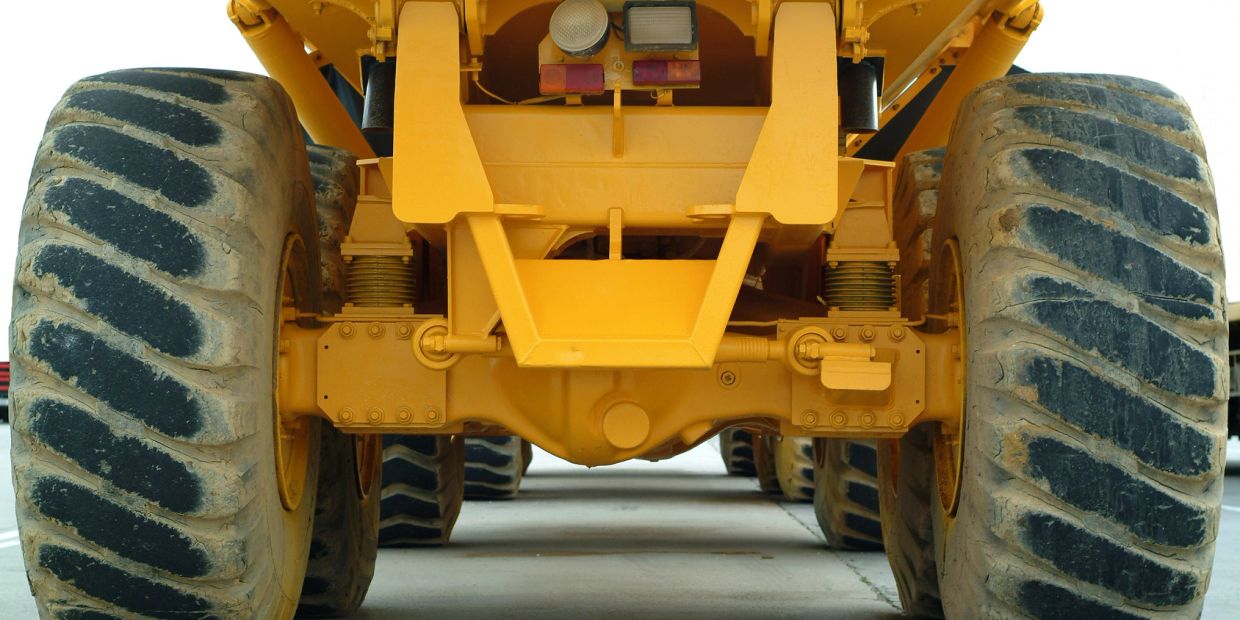 Close-up of large yellow construction vehicle tires.