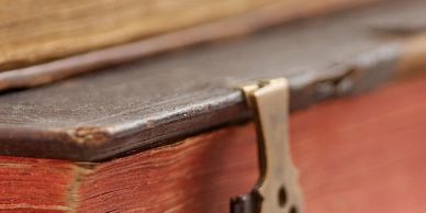 Close-up of an old book with a metal clasp and worn edges.