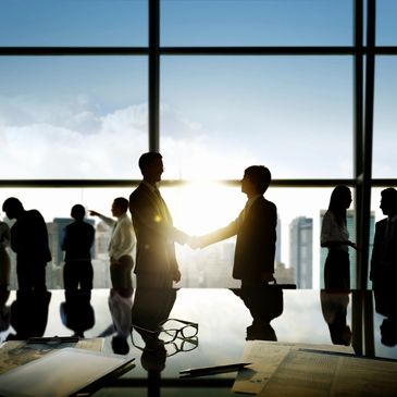 two team leaders shake hands to signal conflict resolution