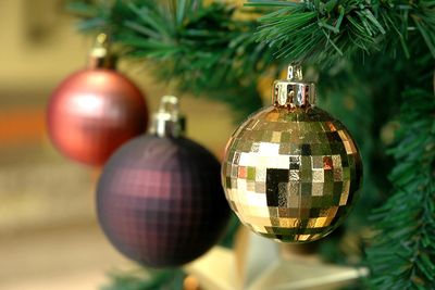 A close up of christmas ornaments on a tree