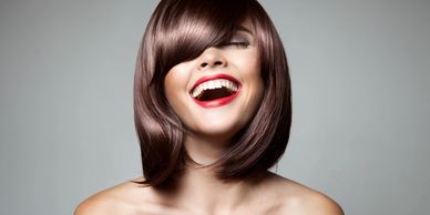 One person brown hair, and red lipstick laughing