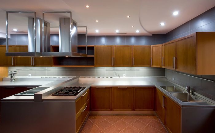 Modern kitchen with wooden cabinets and stainless steel appliances.