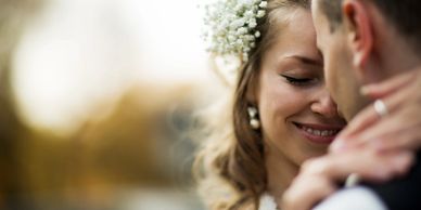 Elopement couple embracing. Bokeh background.