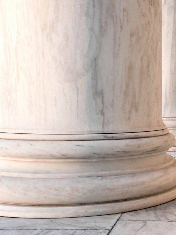 Close-up of a marble column base with intricate details.