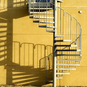 Image of metal spiral staircase with intersected tubes. A perfect example of an Angle-Rite project.