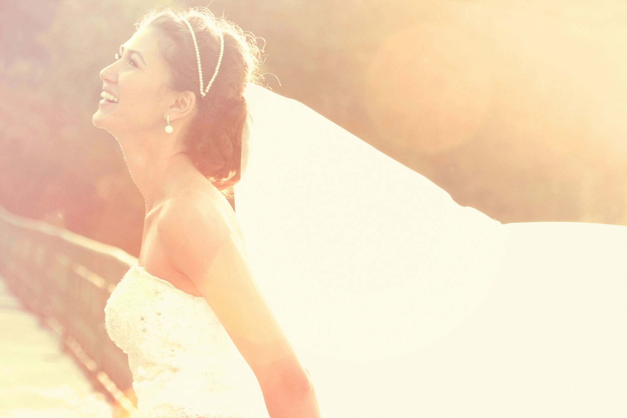Happy bride in side profile with veil 