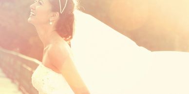 Joyful bride in a sunlit scene.