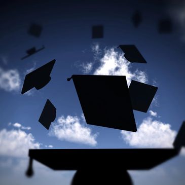 Graduation hats thrown in the air