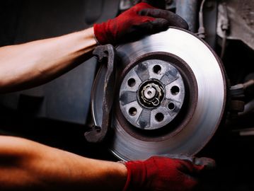 Mechanic working on brakes of a vehicle 