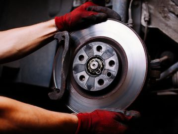 Auto technician servicing brake rotors.