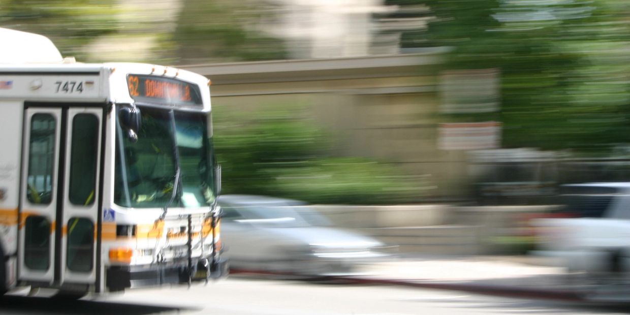 Bus moving quickly on a city street.
