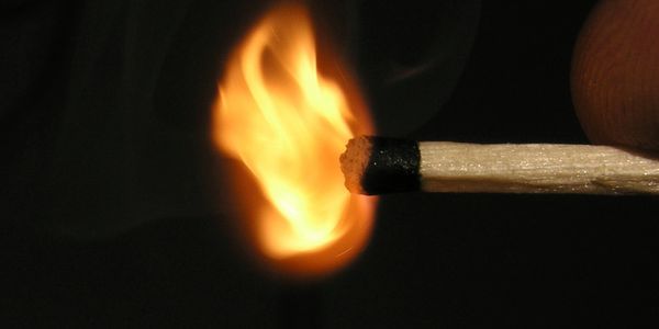 A wooden match just lighting